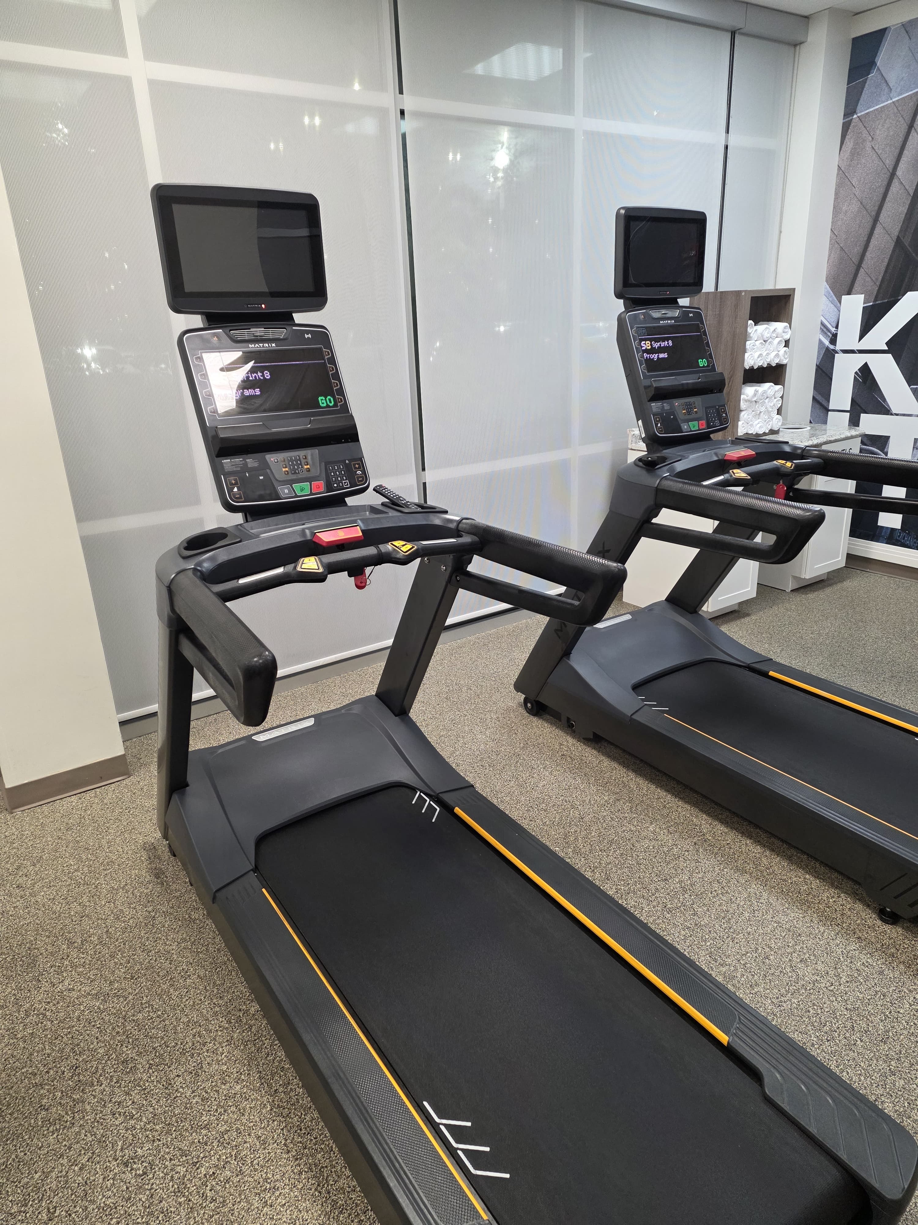 Close view of commercial treadmills placed in a hotel fitness space installed by our team
